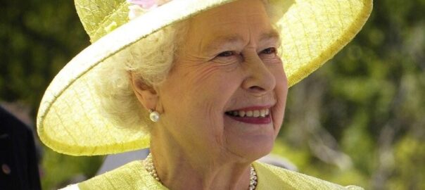 Queen Elizabeth II in a yellow hat.